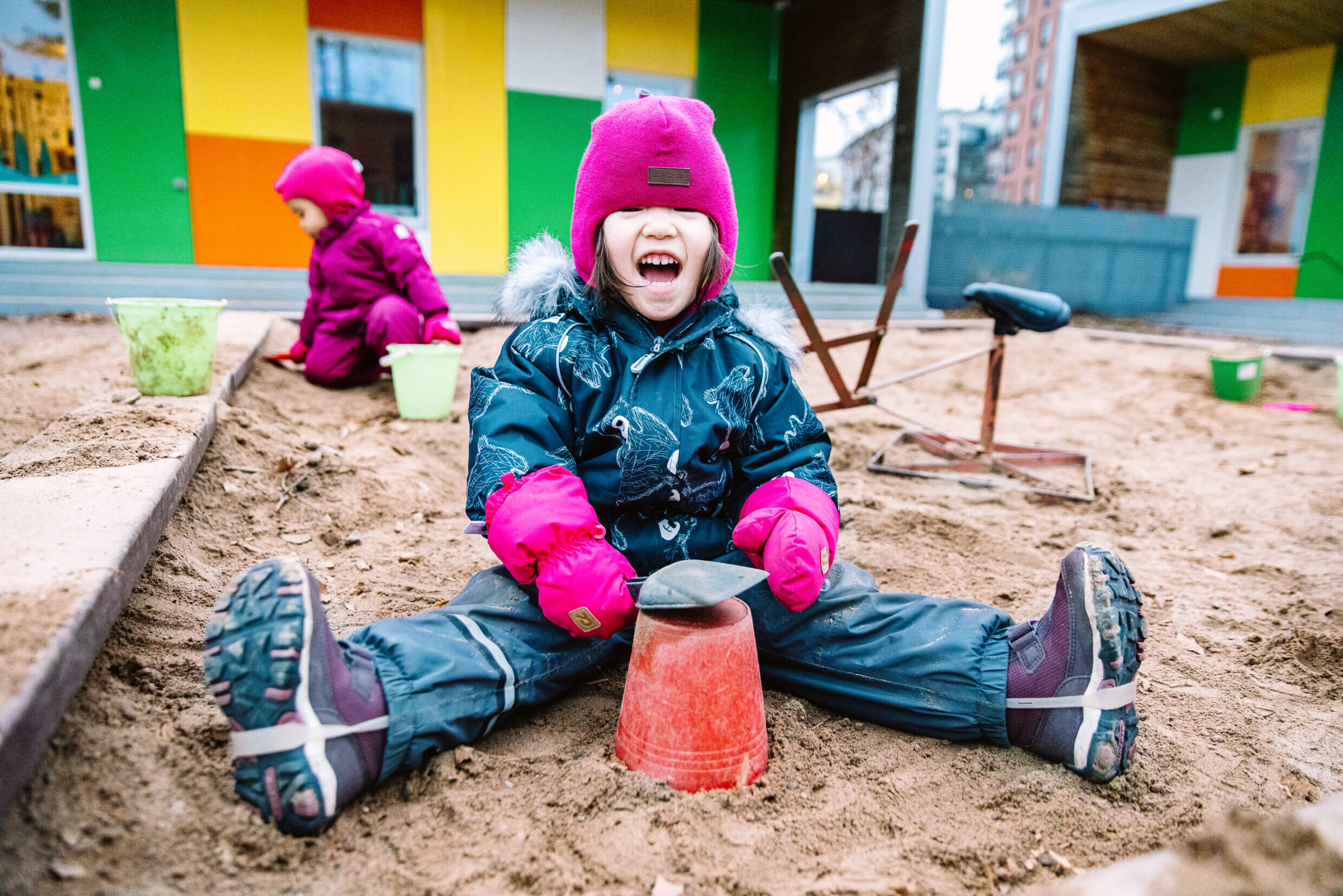 A child playing on a sandbox.